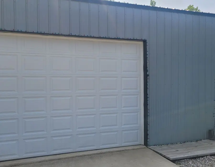The shop's bay door and side entry where keys are dropped off and picked up